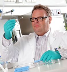Dr Joachim Storsberg holding an artificial cornea