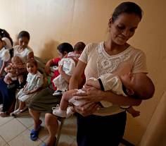 Mother and children wait for rotavirus vaccination