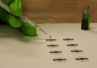 NIST researcher prepares quartz crystal microbalance disks with samples of carbon nanotubes